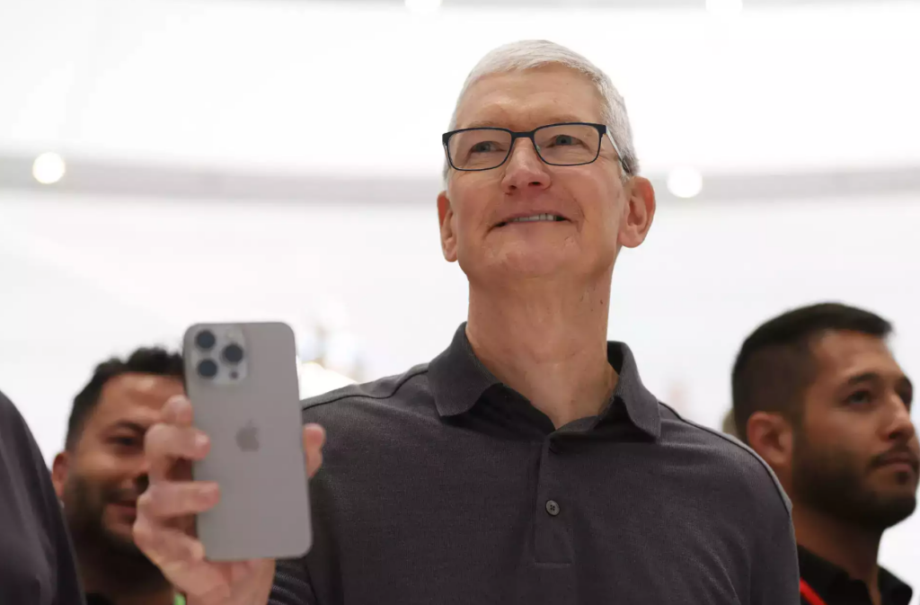 Apple CEO holds an iPhone 15 at the WWDC event